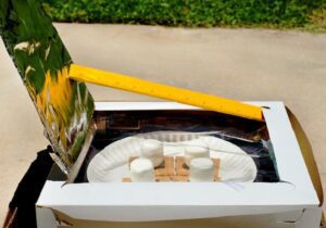 Image of a solar oven with smores inside